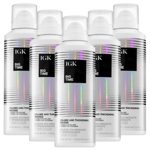 Five bottles of IGK Big Time Volume and Thickening Mousse with holographic design.