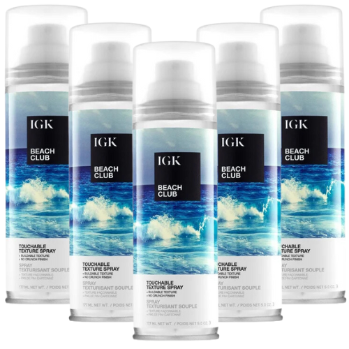 Five bottles of IGK Beach Club Touchable Texture Spray with ocean-themed labels.
