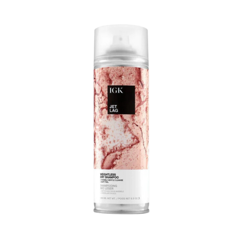 A can of IGK Jet Lag dry shampoo with a pink marble design.