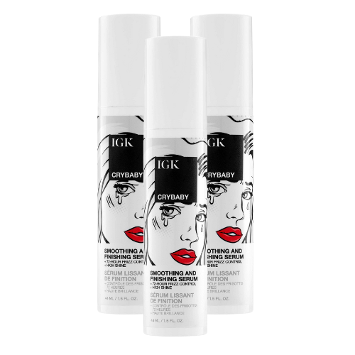 Three IGK Crybaby hair serum bottles with illustrated design.