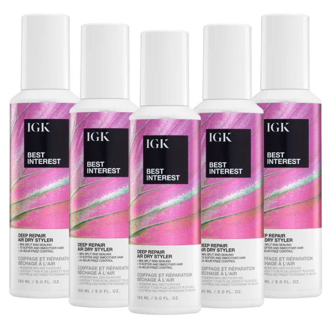 Five bottles of IGK Best Interest Deep Repair Air Dry Styler with pink labels.