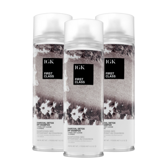 Three cans of IGK First Class charcoal detox dry shampoo.
