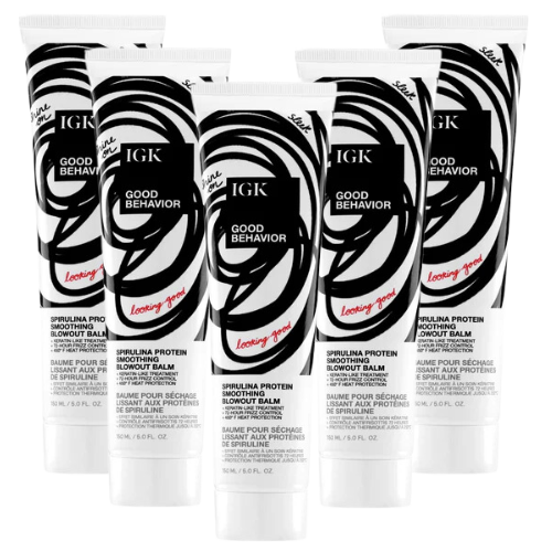 Six tubes of IGK Good Behavior Spirulina Protein Blowout Balm in black and white packaging.
