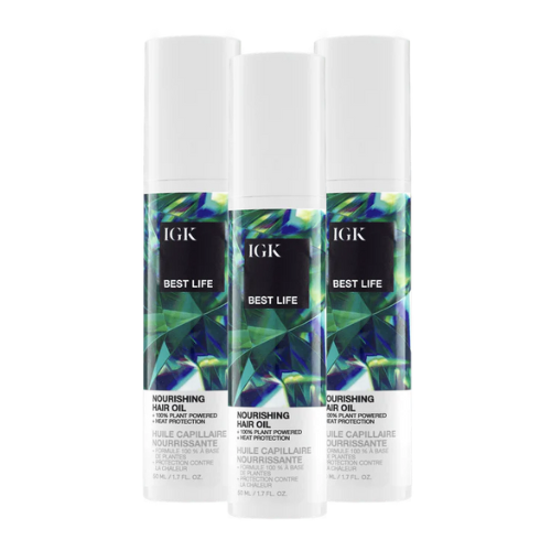 Three bottles of IGK nourishing hair oil.