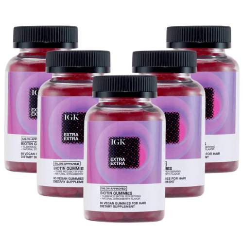 Five bottles of IGK Extra Extra Biotin Gummies, a vegan hair supplement.