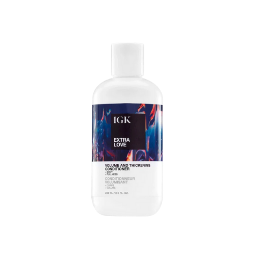 Hair conditioner bottle labeled 'IGK Extra Love Volume and Thickening Conditioner.'