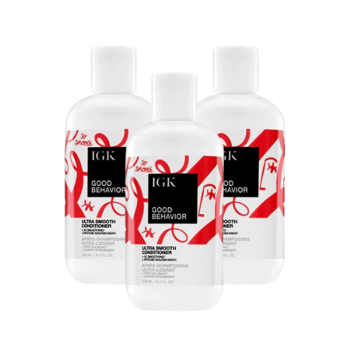 Three bottles of IGK Good Behavior Ultra Smooth Conditioner.