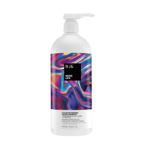 A bottle of IGK More Life Color Extending Gloss Shampoo with colorful label design.