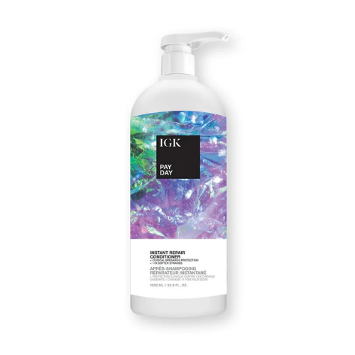 A bottle of IGK Pay Day Instant Repair Conditioner with colorful abstract label.